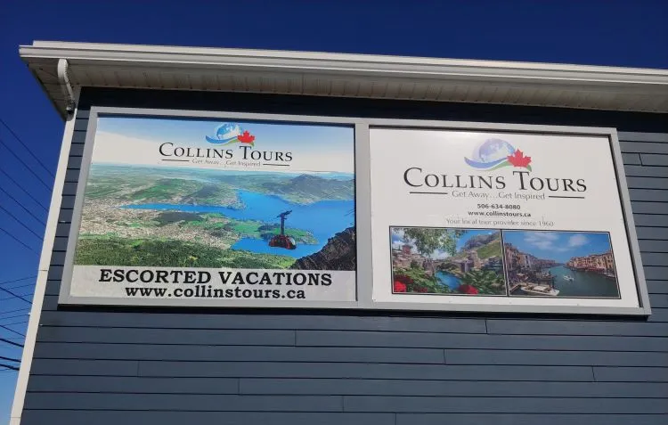 Collins Tours sign installed on the corner of their office building